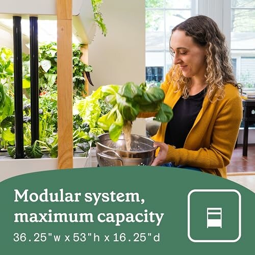 Woman tending to plants in a modular indoor garden system.